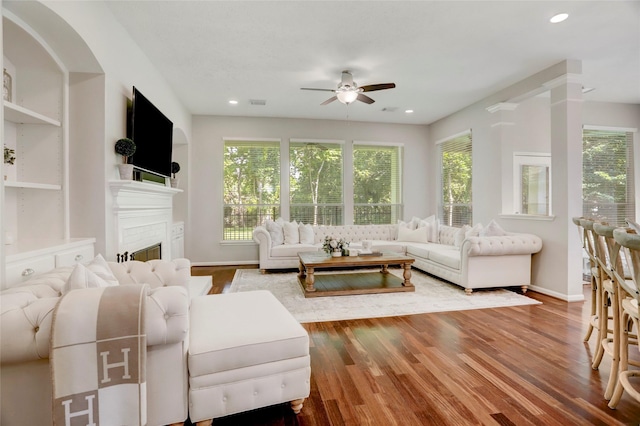 3350 Precinct Line Rd, Richmond, TX 77406 - living room featuring a ceiling fan, wood finished floors, a fireplace, baseboards, and recessed lighting