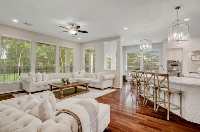 3350 Precinct Line Rd, Richmond, TX 77406 - living area with dark wood finished floors, a ceiling fan, a chandelier, baseboards, and recessed lighting