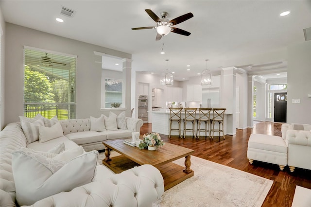 3350 Precinct Line Rd, Richmond, TX 77406 - living room with ceiling fan, dark wood-style floors, recessed lighting, a chandelier, and ornate columns