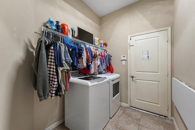 14327 Cranbrook Creek Ln, Houston, TX 77044 - washroom featuring independent washer and dryer, light tile patterned flooring, and baseboards