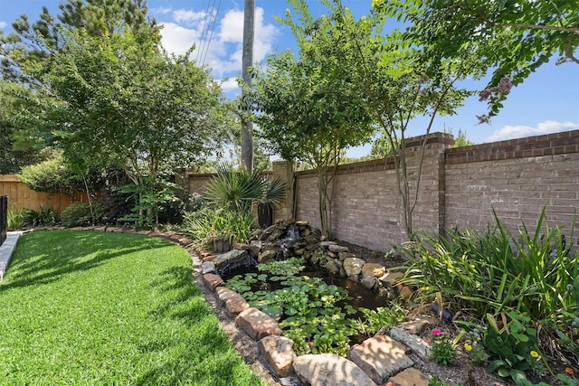 14327 Cranbrook Creek Ln, Houston, TX 77044 - view of yard with a garden pond