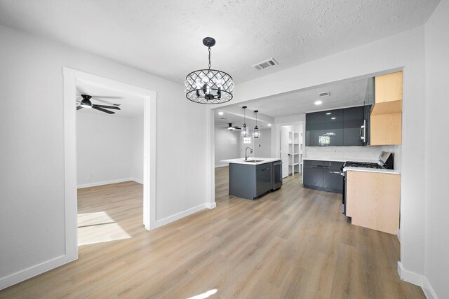 7109 Saint Augustine St, Houston, TX 77021 - kitchen featuring a sink, range with gas stovetop, a chandelier, ceiling fan, and light wood-style flooring