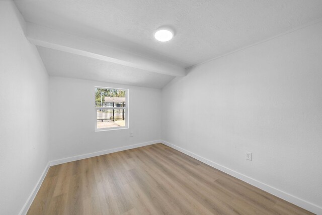 7109 Saint Augustine St, Houston, TX 77021 - additional living space featuring lofted ceiling, wood finished floors, baseboards, and a textured ceiling