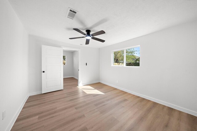 7109 Saint Augustine St, Houston, TX 77021 - unfurnished bedroom featuring light wood finished floors, baseboards, and a ceiling fan