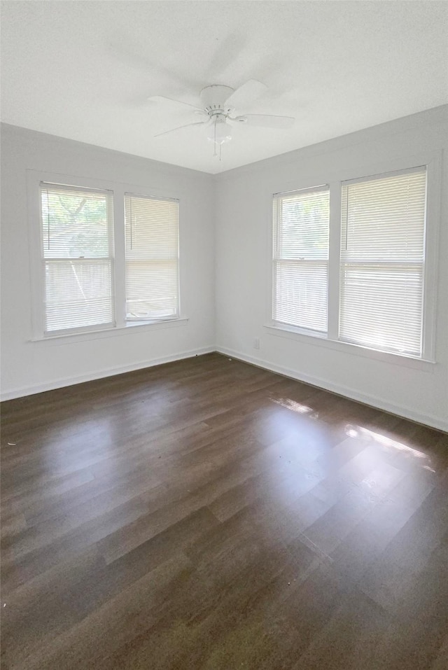 2325 Oaklawn Dr, Port Arthur, TX 77642 - spare room featuring ceiling fan, baseboards, and dark wood-type flooring