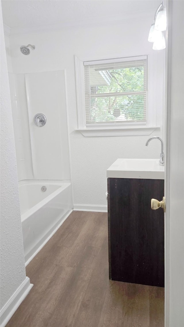2325 Oaklawn Dr, Port Arthur, TX 77642 - bathroom featuring wood finished floors, vanity, shower / washtub combination, and baseboards