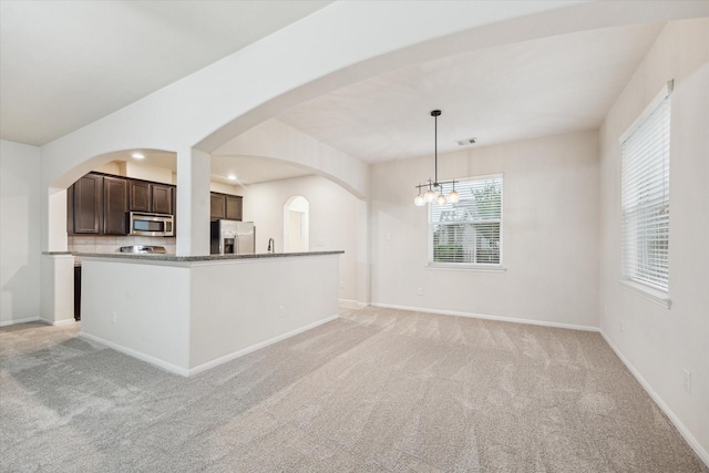 18621 Serenity Loch Dr, Spring, TX 77379 - kitchen featuring stainless steel appliances, light colored carpet, dark brown cabinetry, baseboards, and recessed lighting