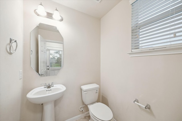 18621 Serenity Loch Dr, Spring, TX 77379 - bathroom with toilet, baseboards, and a sink