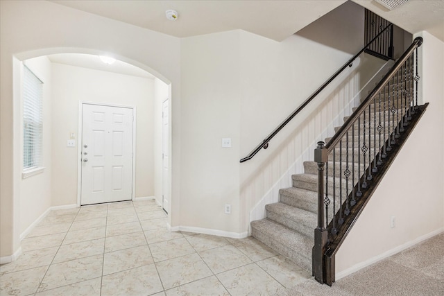 18621 Serenity Loch Dr, Spring, TX 77379 - foyer featuring arched walkways, stairs, and baseboards