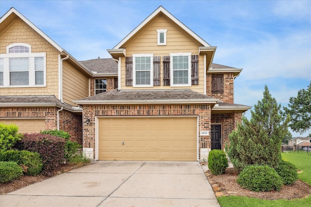 18621 Serenity Loch Dr, Spring, TX 77379 - traditional home featuring a garage, driveway, brick siding, and a shingled roof