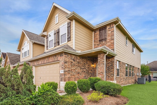 18621 Serenity Loch Dr, Spring, TX 77379 - traditional-style house with brick siding, a garage, a front yard, and central air condition unit