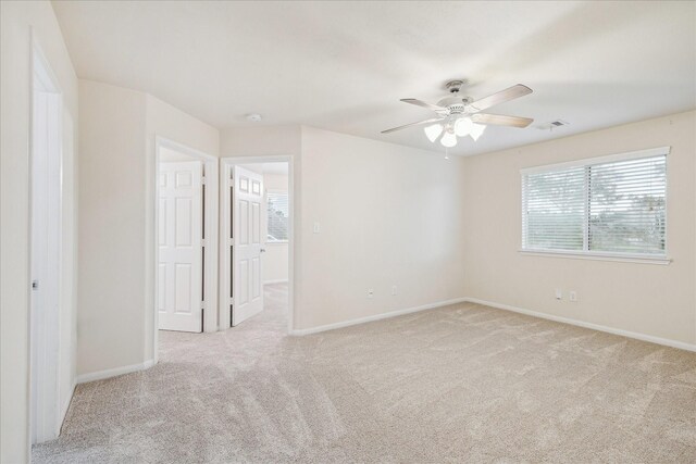 18621 Serenity Loch Dr, Spring, TX 77379 - unfurnished room featuring light carpet, ceiling fan, baseboards, and a smoke detector