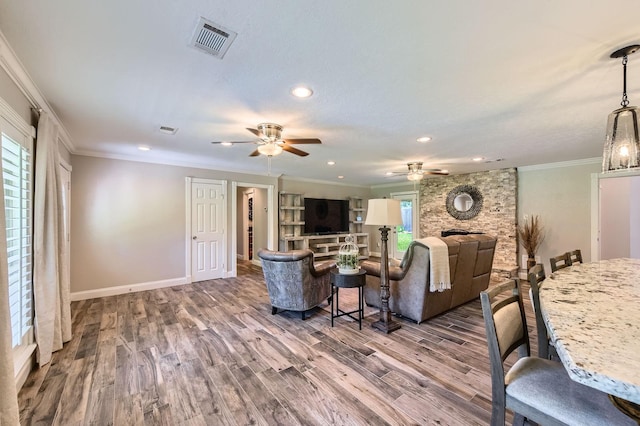 29742 Geneva Dr, Spring, TX 77386 - living room with ceiling fan, wood finished floors, crown molding, baseboards, and recessed lighting