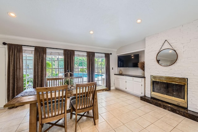 29742 Geneva Dr, Spring, TX 77386 - dining space featuring light tile patterned floors, ornamental molding, a large fireplace, and recessed lighting