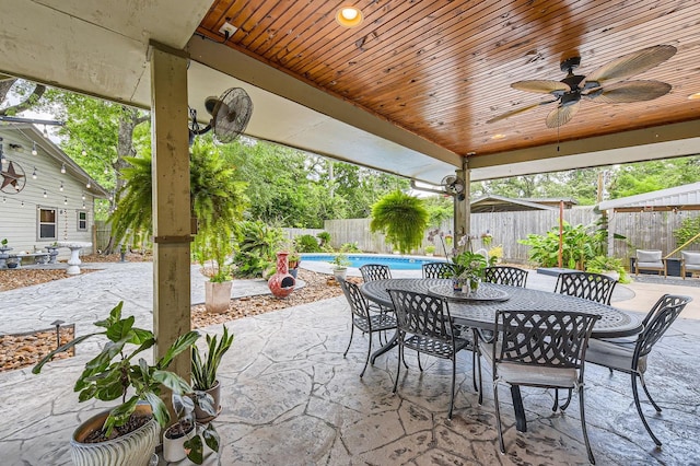 29742 Geneva Dr, Spring, TX 77386 - fenced backyard featuring ceiling fan, a patio area, and outdoor dining space
