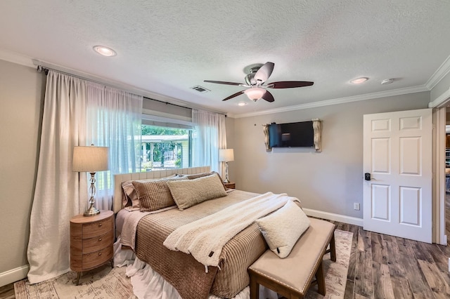 29742 Geneva Dr, Spring, TX 77386 - bedroom with wood finished floors, crown molding, baseboards, a textured ceiling, and a ceiling fan