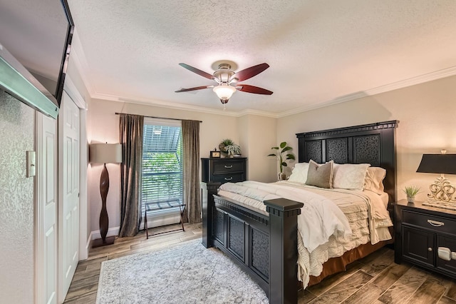 29742 Geneva Dr, Spring, TX 77386 - bedroom featuring light wood-type flooring, ornamental molding, a textured ceiling, a ceiling fan, and baseboards