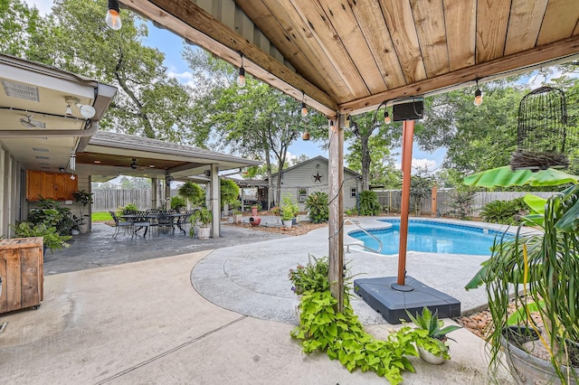 29742 Geneva Dr, Spring, TX 77386 - view of pool with a patio area, a fenced backyard, an outbuilding, and outdoor dining space