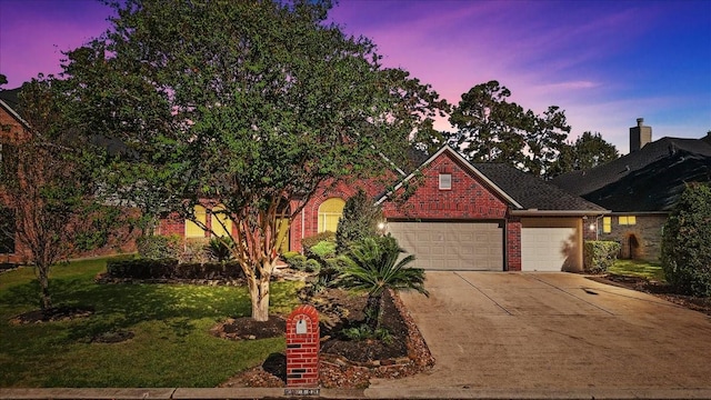 8511 Silver Lure Dr, Humble, TX 77346 - view of front of home featuring a garage, driveway, brick siding, and a front lawn