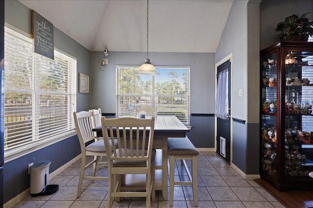 8511 Silver Lure Dr, Humble, TX 77346 - dining area with vaulted ceiling and light tile patterned floors