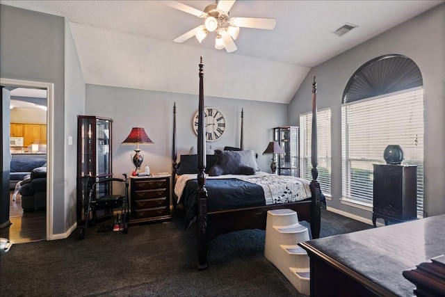 8511 Silver Lure Dr, Humble, TX 77346 - bedroom with dark colored carpet, lofted ceiling, and ceiling fan