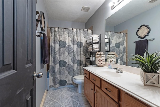 8511 Silver Lure Dr, Humble, TX 77346 - full bath featuring vanity, tile patterned floors, a textured ceiling, and a shower with shower curtain