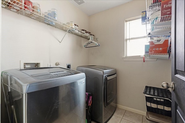 8511 Silver Lure Dr, Humble, TX 77346 - washroom with washing machine and clothes dryer and light tile patterned flooring