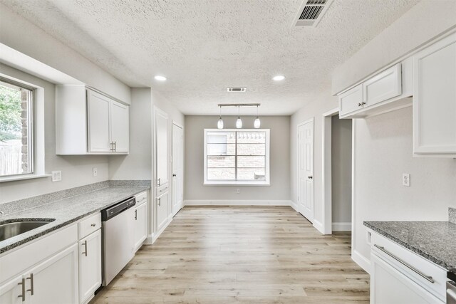 23203 Pennsgrove Rd, Spring, TX 77373 - kitchen featuring a textured ceiling, dishwasher, white cabinets, light wood-style flooring, and recessed lighting