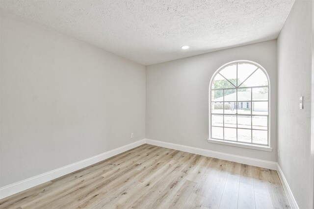 23203 Pennsgrove Rd, Spring, TX 77373 - empty room with a textured ceiling, light wood-type flooring, baseboards, and recessed lighting