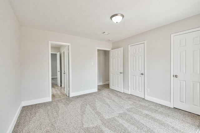 23203 Pennsgrove Rd, Spring, TX 77373 - unfurnished bedroom featuring carpet floors, baseboards, a textured ceiling, and a closet