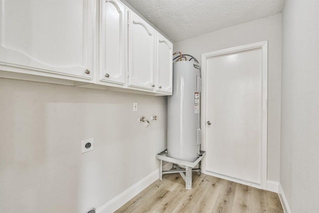 23203 Pennsgrove Rd, Spring, TX 77373 - laundry room featuring water heater, hookup for an electric dryer, light wood finished floors, cabinet space, and baseboards