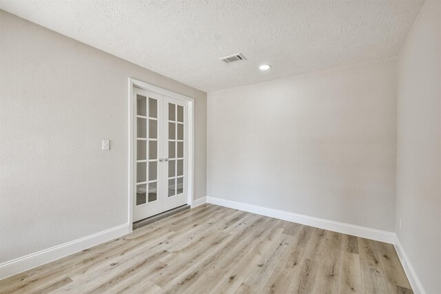 23203 Pennsgrove Rd, Spring, TX 77373 - unfurnished room with french doors, wood finished floors, a textured ceiling, and baseboards