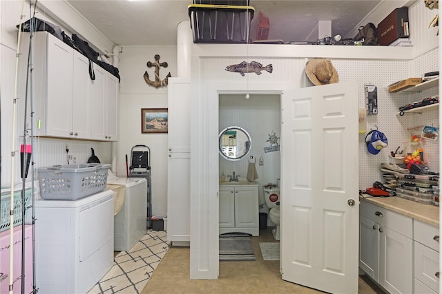 1114 Tiki Dr, Galveston, TX 77554 - washroom featuring cabinet space and washer and clothes dryer