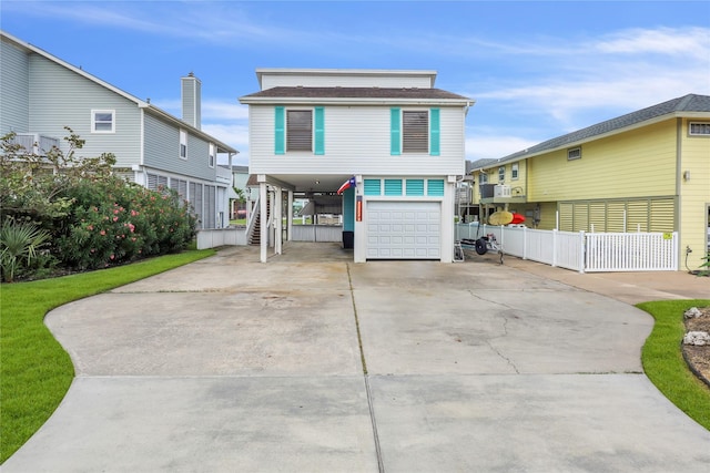1114 Tiki Dr, Galveston, TX 77554 - raised beach house with driveway, a carport, an attached garage, and stairway