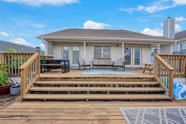 1114 Tiki Dr, Galveston, TX 77554 - rear view of property with french doors, a deck, an outdoor living space, and a shingled roof