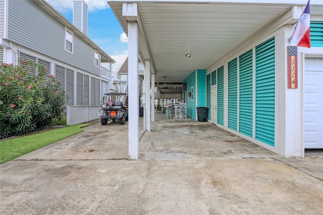 1114 Tiki Dr, Galveston, TX 77554 - view of patio / terrace featuring driveway and an attached carport