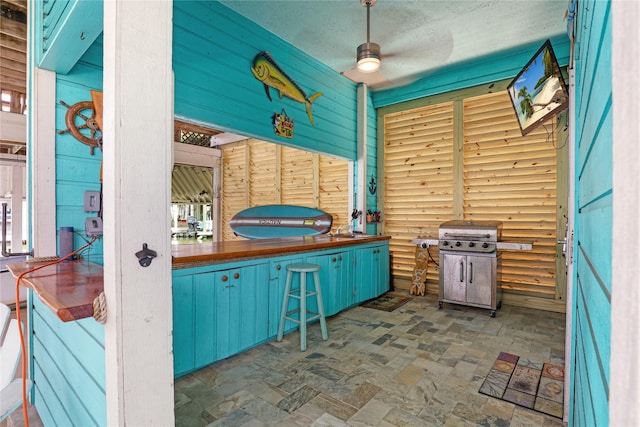 1114 Tiki Dr, Galveston, TX 77554 - view of patio / terrace with grilling area and ceiling fan