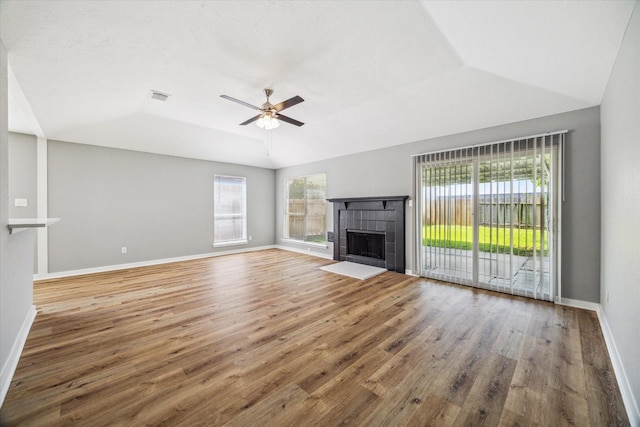 16739 Sky Blue Ln, Houston, TX 77095 - unfurnished living room with plenty of natural light, wood finished floors, a ceiling fan, and vaulted ceiling