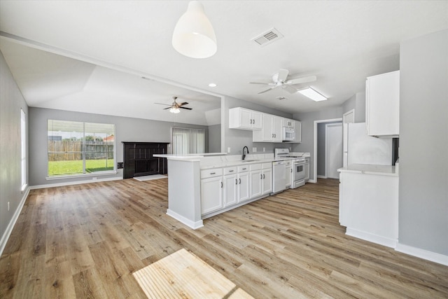 16739 Sky Blue Ln, Houston, TX 77095 - kitchen featuring white appliances, ceiling fan, a sink, open floor plan, and light wood finished floors