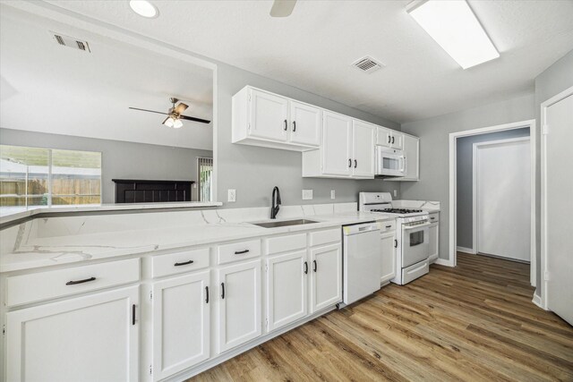 16739 Sky Blue Ln, Houston, TX 77095 - kitchen featuring a sink, white appliances, ceiling fan, white cabinetry, and light wood-style floors
