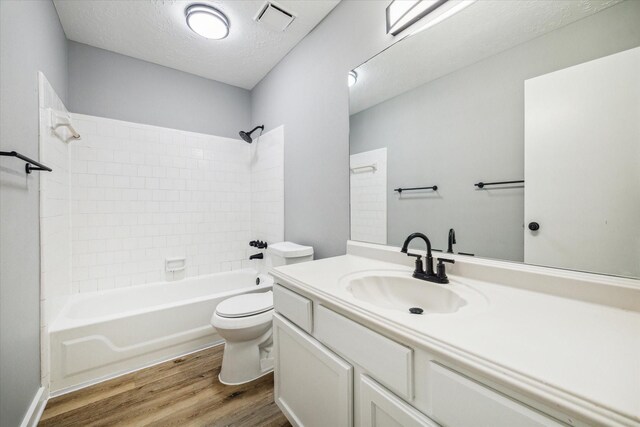 16739 Sky Blue Ln, Houston, TX 77095 - bathroom with toilet, wood finished floors, vanity, shower / tub combination, and a textured ceiling