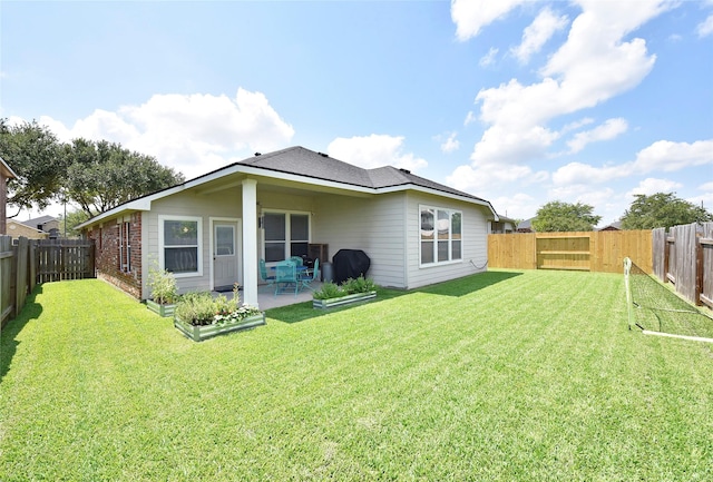 711 Shenandoah Falls Ln, Rosenberg, TX 77469 - rear view of house featuring a patio, roof with shingles, and brick siding
