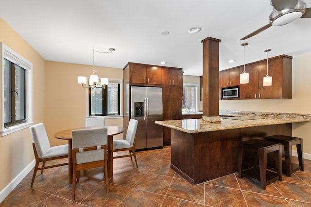 6401 Bayou Glen Rd, Houston, TX 77057 - kitchen with stainless steel appliances, plenty of natural light, a peninsula, decorative light fixtures, and recessed lighting