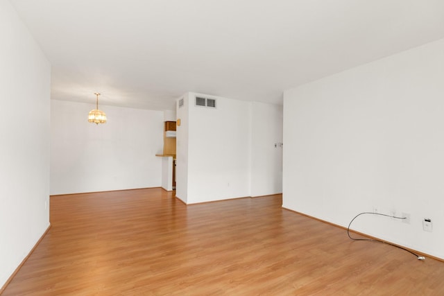 3131 Cummins St Unit 50, Houston, TX 77027 - spare room with light wood-style flooring and a chandelier