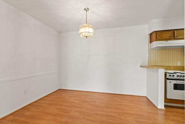 3131 Cummins St Unit 50, Houston, TX 77027 - unfurnished dining area featuring a chandelier, light wood finished floors, and baseboards