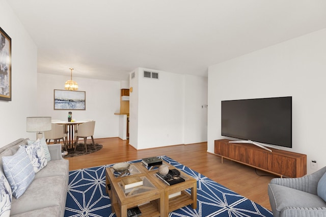 3131 Cummins St Unit 50, Houston, TX 77027 - living area with wood finished floors and a chandelier