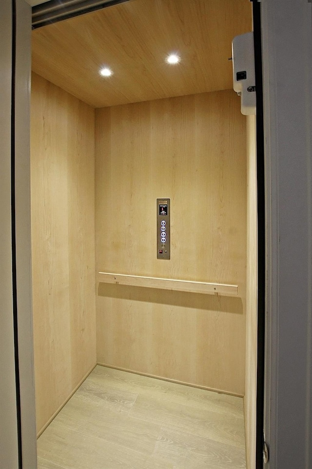 821 Dunleigh Meadows Ln, Houston, TX 77055 - elevator with wood finished floors, recessed lighting, wood ceiling, and wood walls