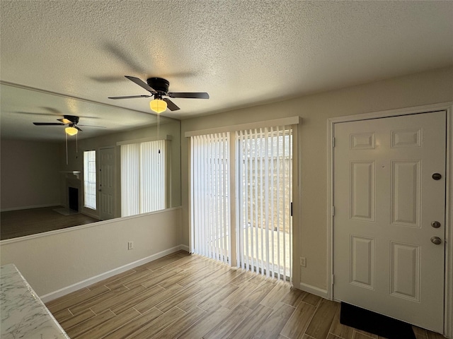 6500 Sands Point Dr Unit 114, Houston, TX 77074 - entrance foyer featuring baseboards, ceiling fan, a textured ceiling, and wood finished floors