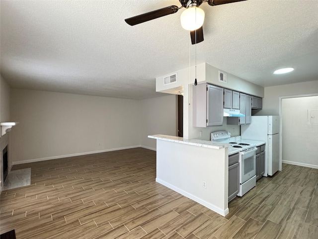 6500 Sands Point Dr Unit 114, Houston, TX 77074 - kitchen featuring white appliances, wood finish floors, a ceiling fan, baseboards, and a textured ceiling
