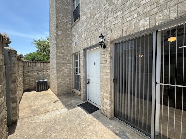 6500 Sands Point Dr Unit 114, Houston, TX 77074 - view of exterior entry with central AC and brick siding